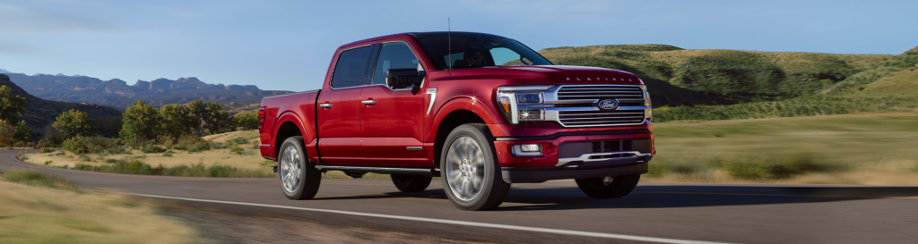 A new red Ford F-150 driving on the open road, making the F-150 truck a perfect choice for your holiday travel plans this year! Shop for your new Ford F-150 truck at Ford of Spartanburg!